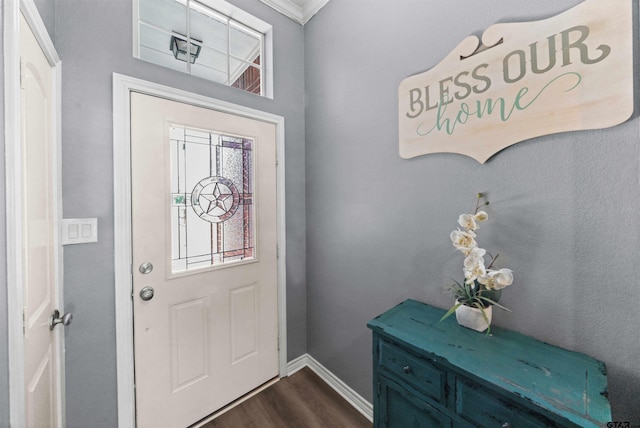 foyer entrance featuring dark hardwood / wood-style flooring and crown molding