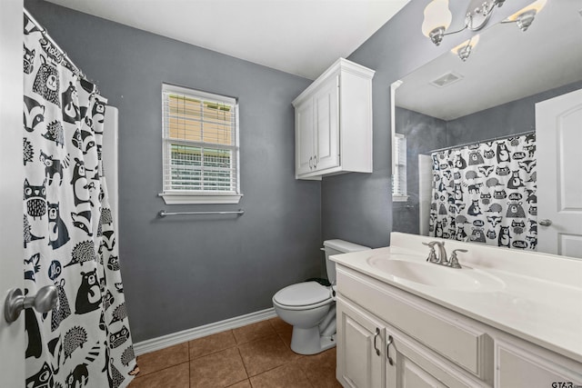 bathroom featuring toilet, vanity, tile patterned floors, and a shower with shower curtain