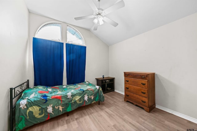 bedroom with ceiling fan, wood-type flooring, and vaulted ceiling