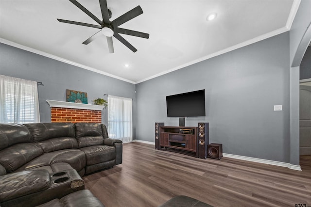 living room featuring dark hardwood / wood-style floors, ceiling fan, and crown molding