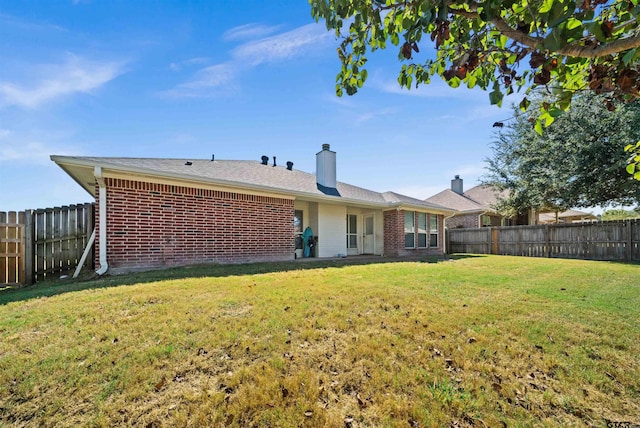 back of property featuring a lawn