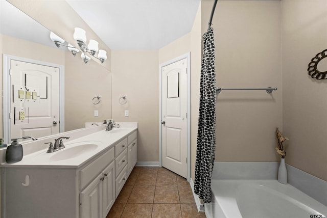 bathroom featuring a bathtub, vanity, and tile patterned flooring