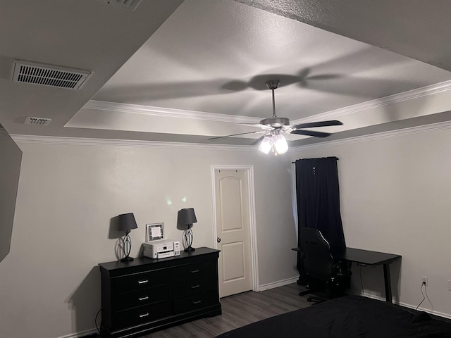 bedroom with dark hardwood / wood-style floors, a raised ceiling, ceiling fan, and crown molding