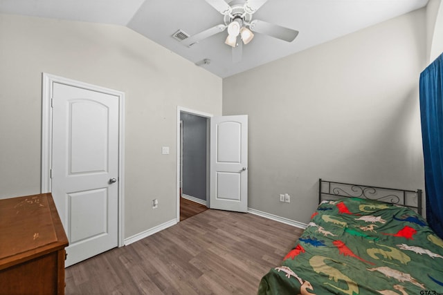 bedroom with ceiling fan, wood-type flooring, and vaulted ceiling