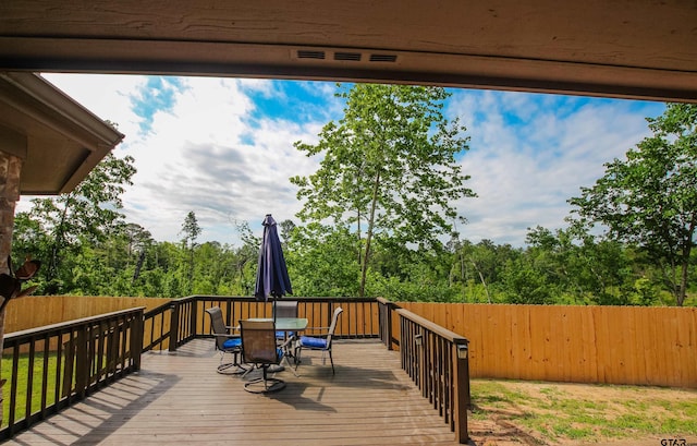 deck featuring fence and outdoor dining space