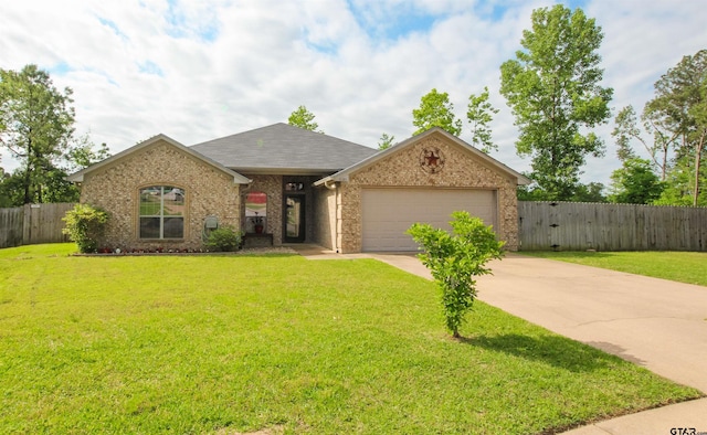 view of front of house featuring a garage, fence, a front yard, brick siding, and driveway