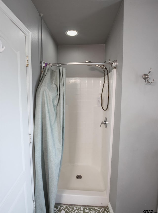 bathroom with tiled shower