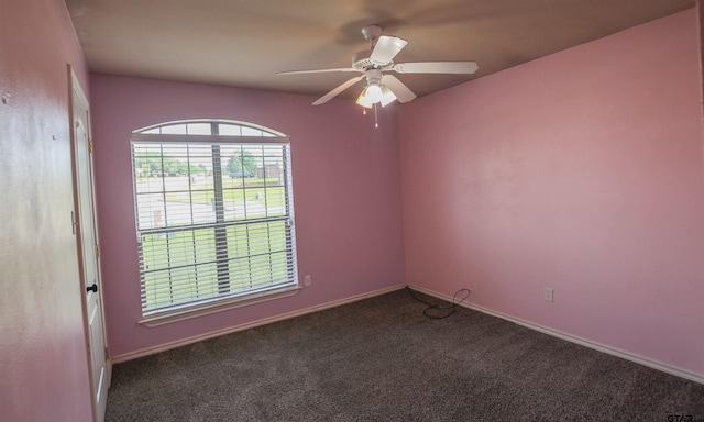 unfurnished room with carpet floors, a ceiling fan, and baseboards