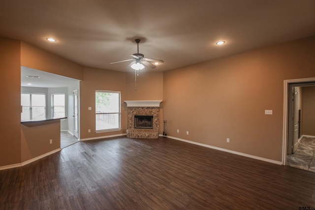 5878 Palo Pinto Dr, Tyler, TX 75707 - unfurnished living room featuring ceiling fan, dark wood-style flooring, a fireplace with raised hearth, and recessed lighting