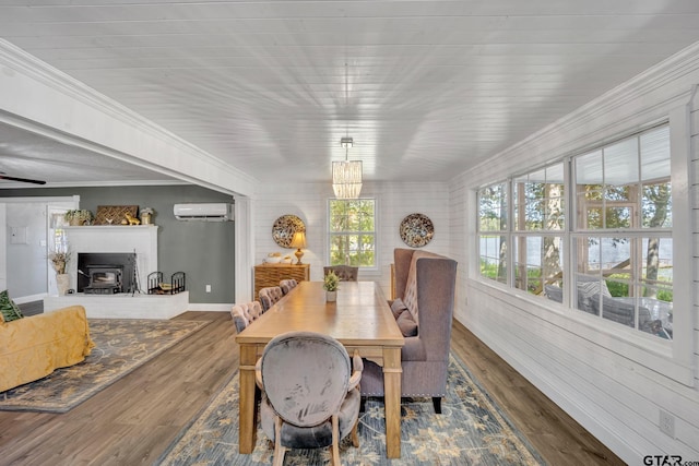 dining space featuring hardwood / wood-style flooring, ornamental molding, and a wall unit AC