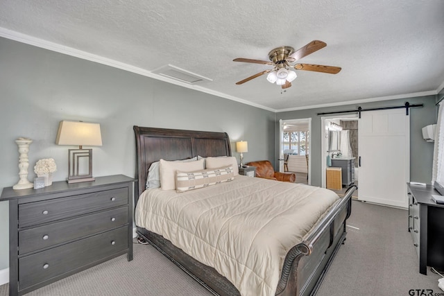 carpeted bedroom with crown molding, a barn door, ceiling fan, and a textured ceiling