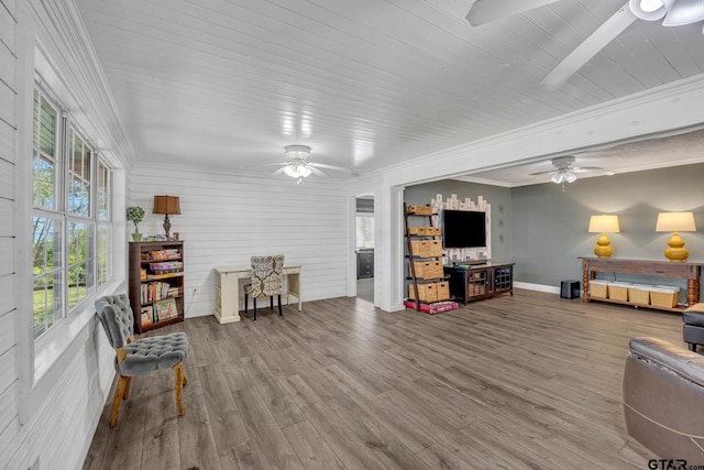 living room with hardwood / wood-style flooring, ornamental molding, and a wealth of natural light