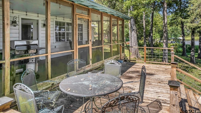 wooden terrace featuring a sunroom