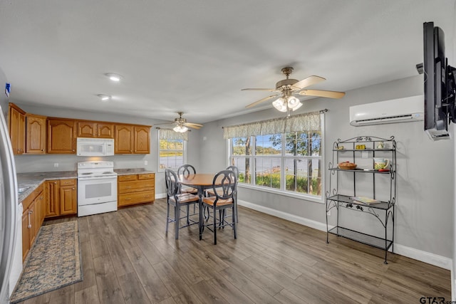 kitchen with ceiling fan, white appliances, wood-type flooring, and a wall unit AC