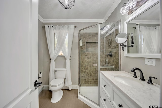 bathroom with crown molding, an enclosed shower, a textured ceiling, and vanity