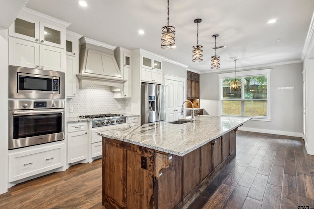 kitchen featuring dark wood-type flooring, white cabinetry, a kitchen island with sink, and appliances with stainless steel finishes