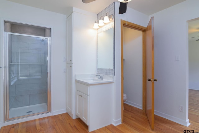 112 Lakeview St, Whitehouse, TX 75791 - bathroom featuring a ceiling fan, vanity, wood finished floors, and a shower stall