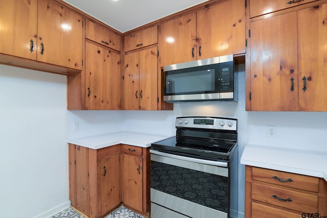 112 Lakeview St, Whitehouse, TX 75791 - kitchen featuring stainless steel appliances, light countertops, and brown cabinetry