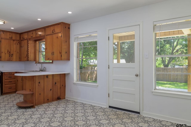 112 Lakeview St, Whitehouse, TX 75791 - kitchen with healthy amount of natural light, brown cabinets, light countertops, and recessed lighting