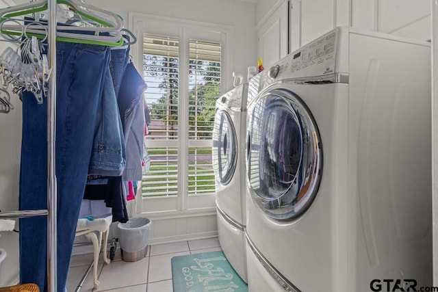 laundry area featuring light tile patterned floors and washer and dryer