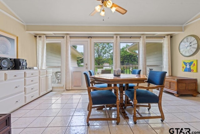 dining room with vaulted ceiling, ceiling fan, and crown molding