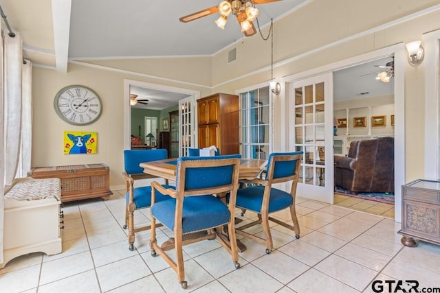 dining space featuring french doors, light tile patterned floors, and lofted ceiling