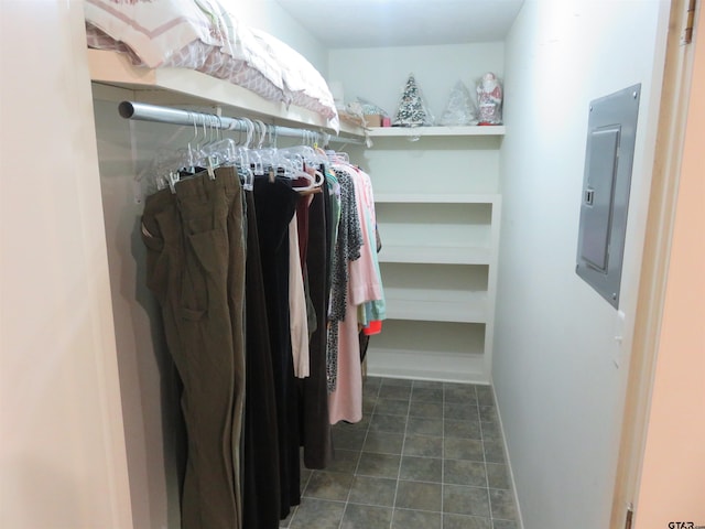 walk in closet featuring dark tile patterned floors and electric panel