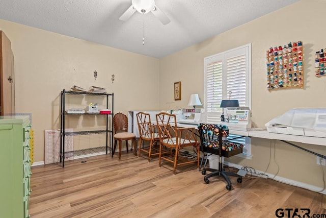 office space featuring ceiling fan and light hardwood / wood-style flooring