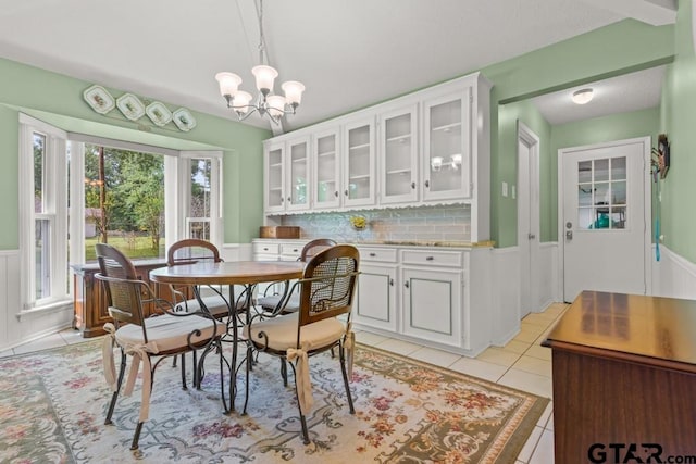 dining room featuring light tile patterned flooring and a chandelier