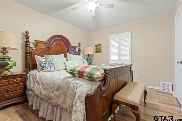 bedroom featuring light hardwood / wood-style flooring and ceiling fan