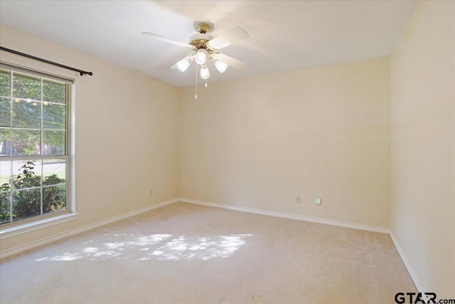 unfurnished room with light colored carpet and ceiling fan