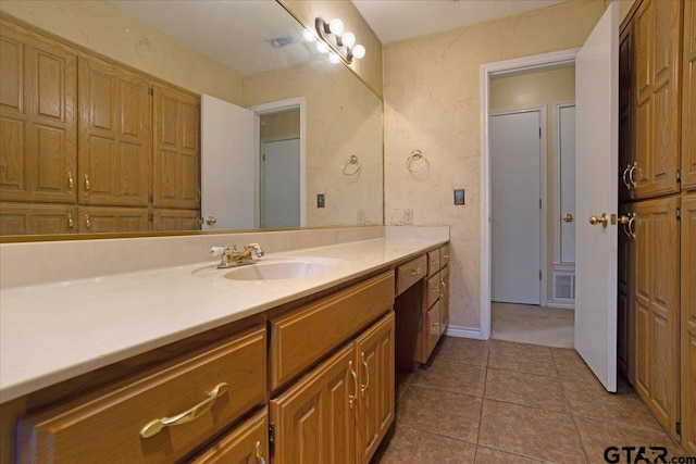 bathroom with tile patterned flooring and vanity