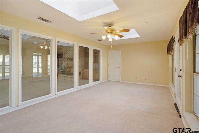 unfurnished sunroom with a skylight and ceiling fan