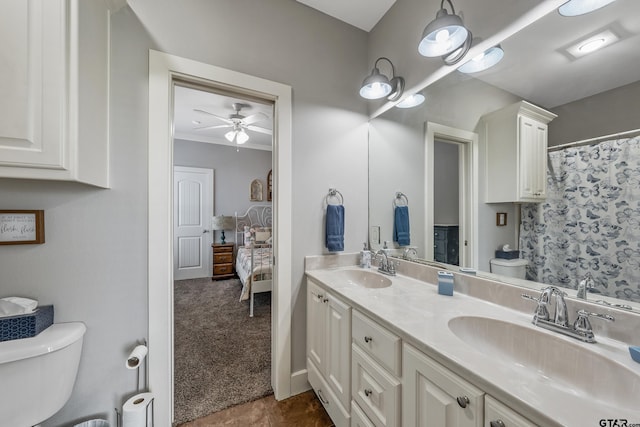 bathroom featuring vanity, ornamental molding, ceiling fan, and toilet