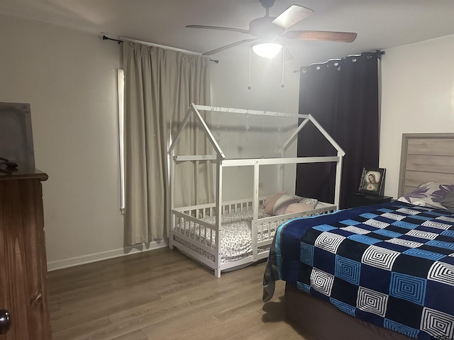 bedroom featuring a ceiling fan and wood finished floors