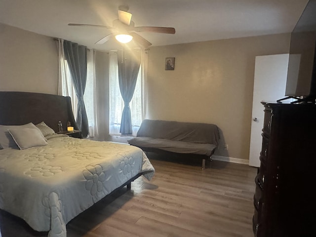 bedroom with a ceiling fan and light wood-type flooring