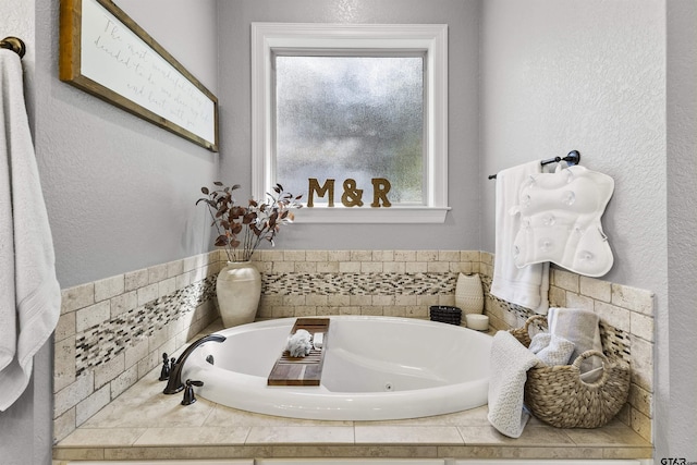 bathroom featuring tiled tub