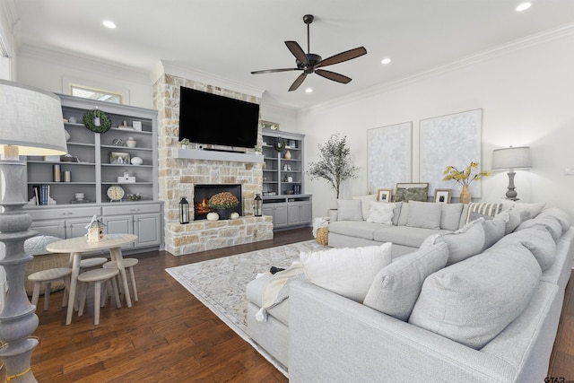 living room featuring a fireplace, dark hardwood / wood-style floors, ceiling fan, and ornamental molding