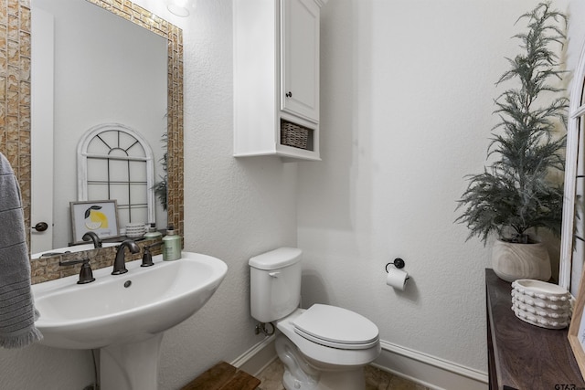 bathroom featuring sink and toilet