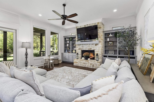 living room featuring ceiling fan, a healthy amount of sunlight, and ornamental molding