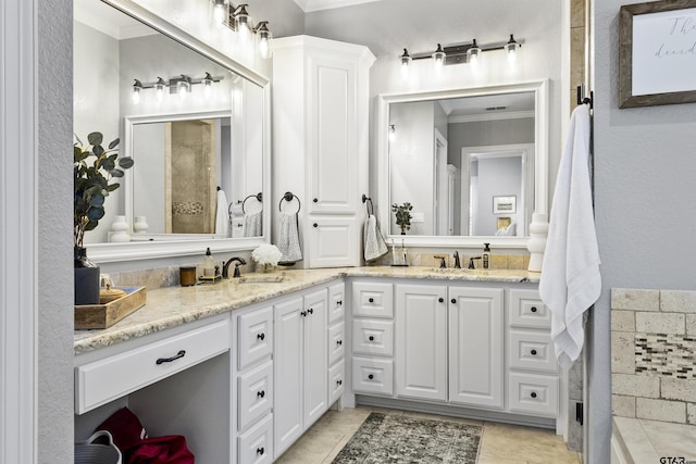 bathroom with tile patterned flooring, vanity, and crown molding