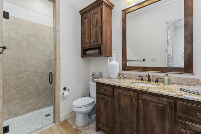 bathroom with tile patterned flooring, vanity, a shower with shower door, and toilet