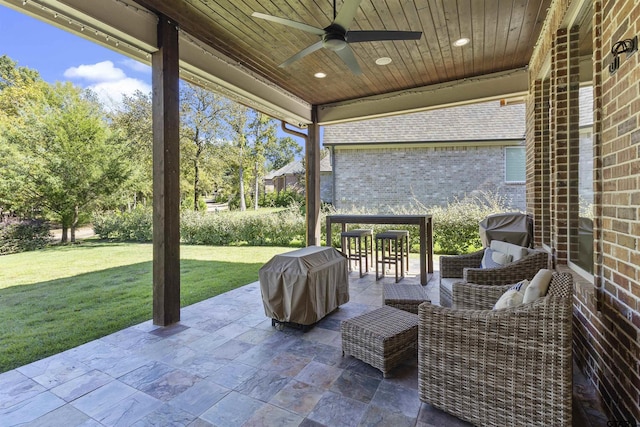 view of patio with area for grilling and ceiling fan