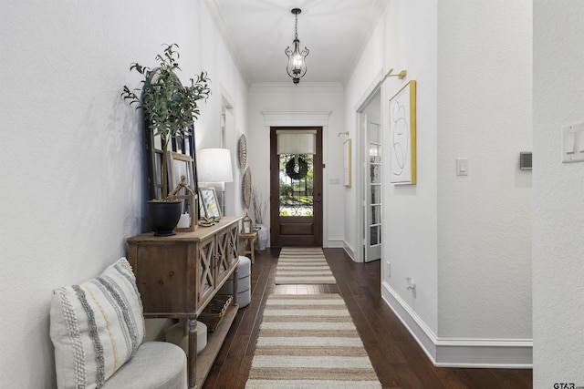 entryway with dark wood-type flooring and ornamental molding