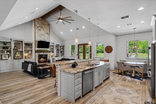 185 Vz County Road 2103, Canton, TX 75103 - kitchen featuring stainless steel appliances, gray cabinets, a stone fireplace, light wood finished floors, and open floor plan