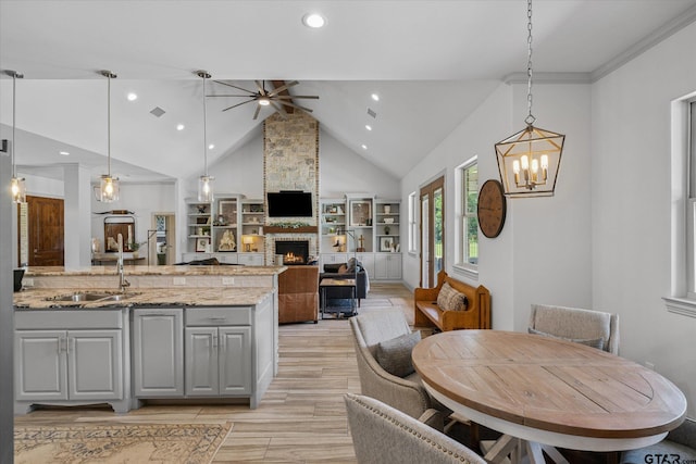 185 Vz County Road 2103, Canton, TX 75103 - kitchen with gray cabinets, ceiling fan, a fireplace, recessed lighting, and a chandelier