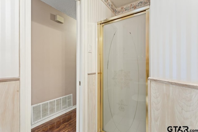 1656 Pineview Ln, Hideaway, TX 75771 - full bath with wallpapered walls, a shower stall, wainscoting, and wood finished floors