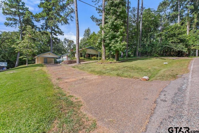 1656 Pineview Ln, Hideaway, TX 75771 - view of front facade with driveway, a front yard, and a carport