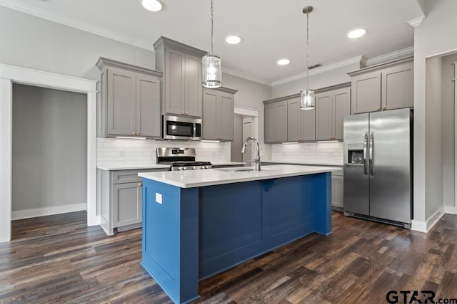 228 Smith Cir, Lindale, TX 75771 - kitchen with appliances with stainless steel finishes, gray cabinets, ornamental molding, tasteful backsplash, and an island with sink