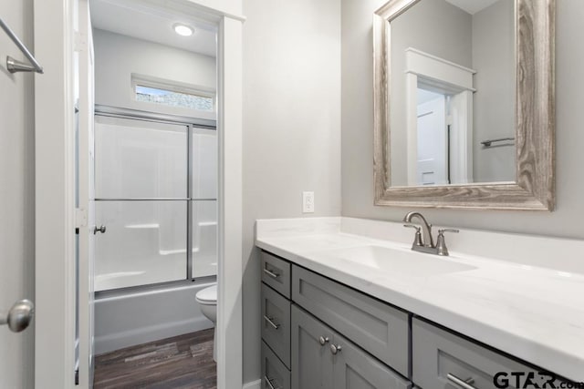 228 Smith Cir, Lindale, TX 75771 - full bath featuring vanity, wood finished floors, and shower / bath combination with glass door
